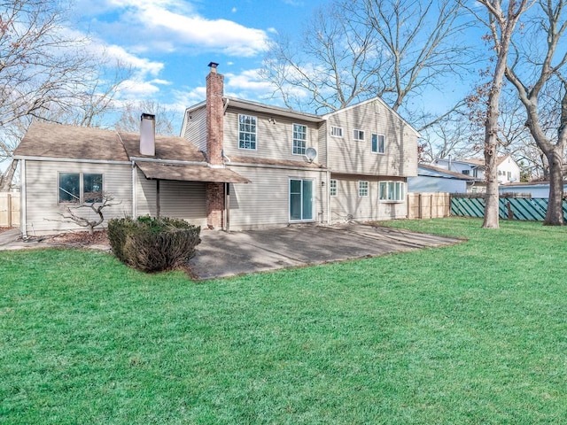 rear view of property with a patio and a lawn