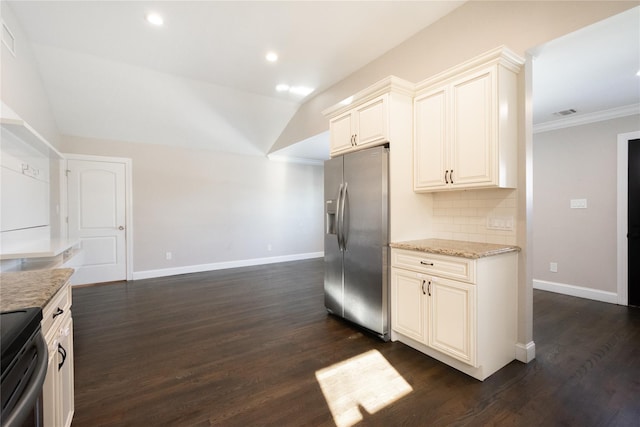 kitchen with decorative backsplash, appliances with stainless steel finishes, light stone counters, vaulted ceiling, and dark hardwood / wood-style floors