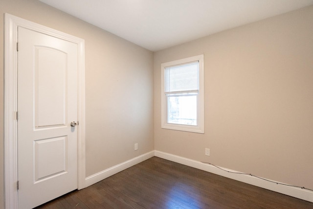 spare room with dark wood-type flooring