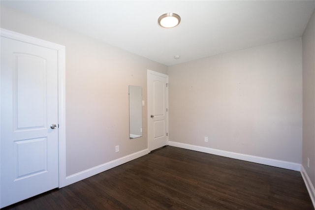 spare room with dark hardwood / wood-style flooring