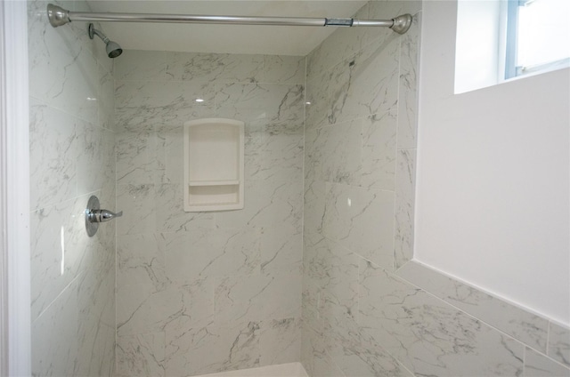 bathroom with tiled shower