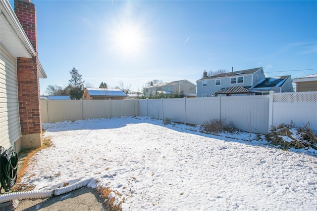 view of yard layered in snow