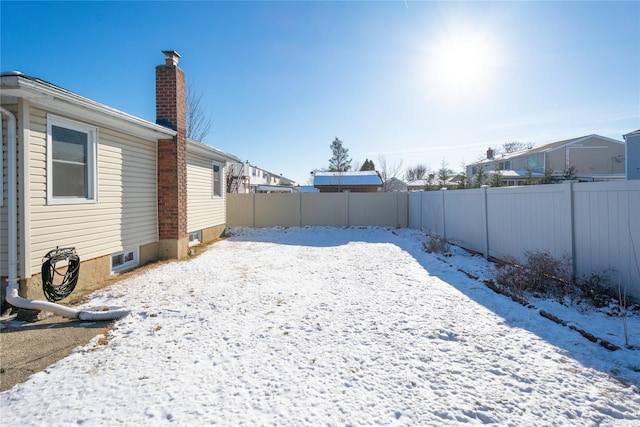 view of yard layered in snow