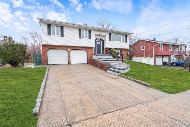 bi-level home with a garage and a front lawn