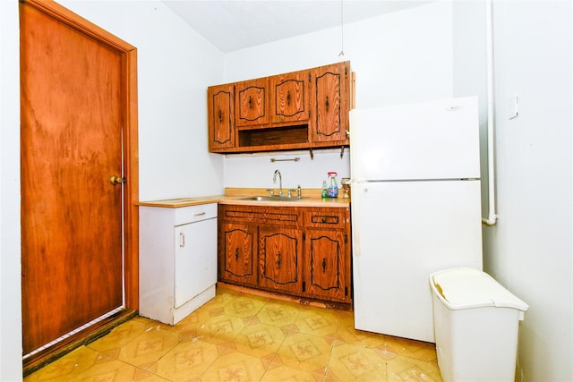 kitchen featuring sink and white refrigerator