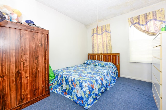 carpeted bedroom featuring a textured ceiling