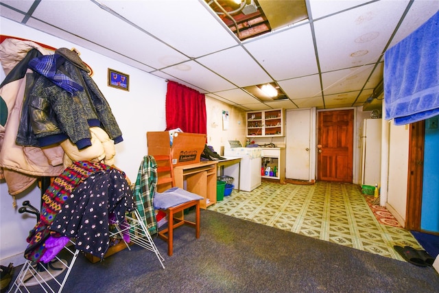 interior space with a paneled ceiling and washer / dryer