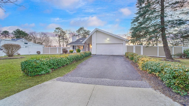 view of front of property with a garage and a front lawn