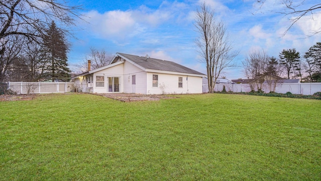 back of house featuring a yard