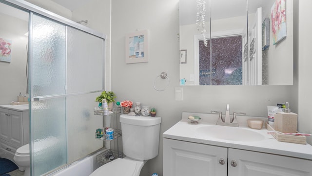 full bathroom with shower / bath combination with glass door, vanity, and toilet