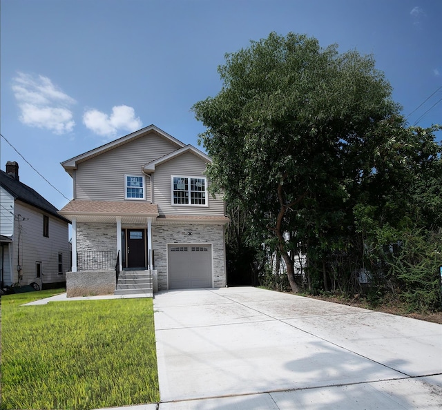 view of front facade with covered porch, a garage, and a front lawn