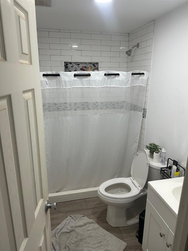 bathroom featuring a shower with curtain, vanity, and toilet