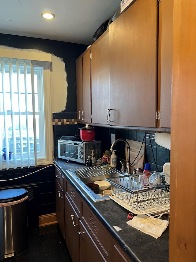 kitchen with dark brown cabinets and sink