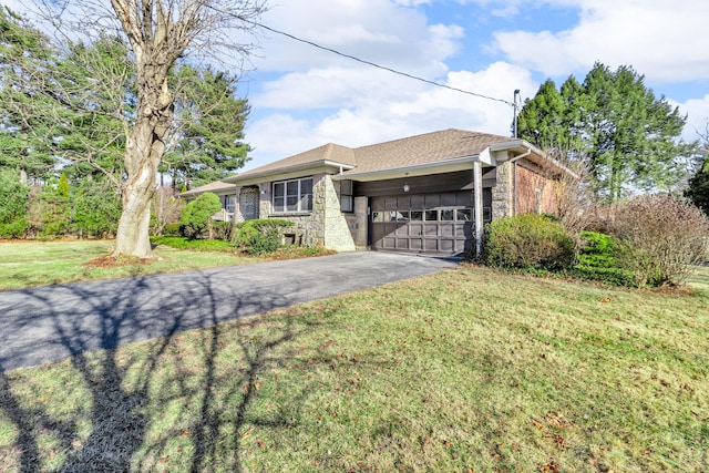 single story home featuring a garage and a front lawn