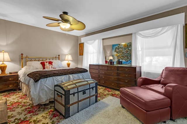 bedroom with ceiling fan and crown molding