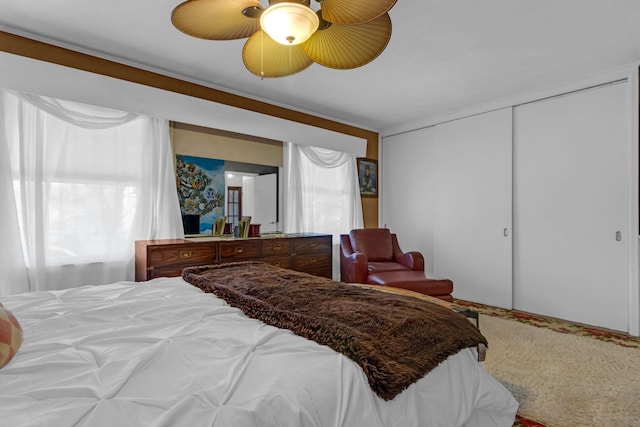 bedroom with ceiling fan and a closet