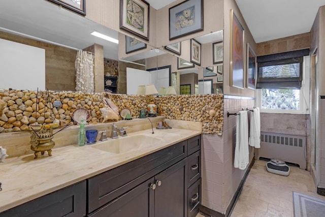 bathroom with a shower with curtain, radiator heating unit, vanity, and tile walls