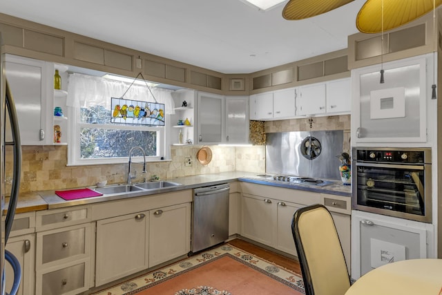 kitchen featuring decorative backsplash, ceiling fan, sink, and stainless steel appliances