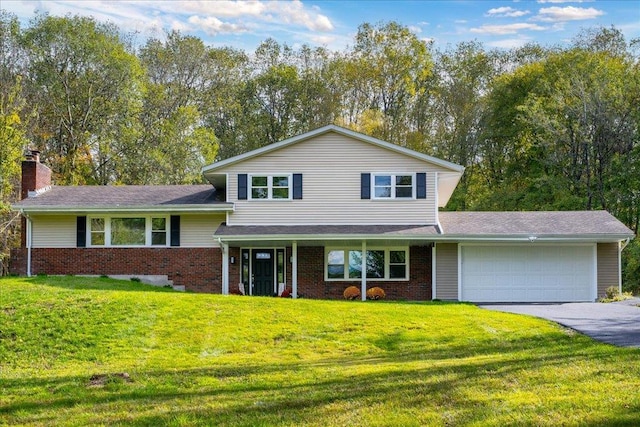 split level home with a front yard and a garage