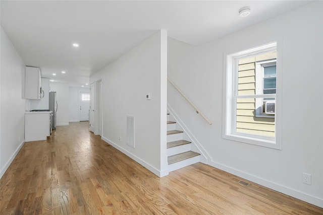 interior space featuring hardwood / wood-style floors, plenty of natural light, and cooling unit