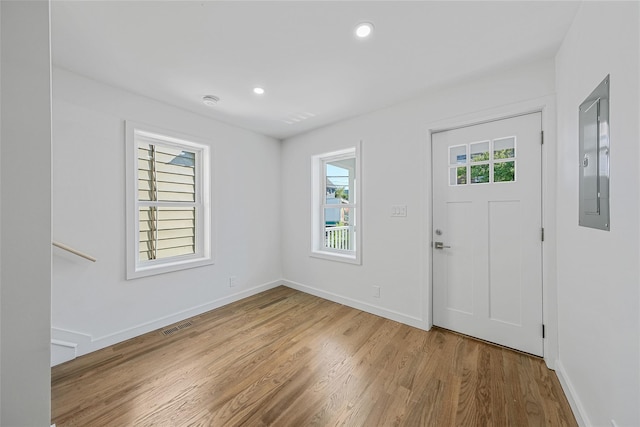 foyer with wood-type flooring and electric panel