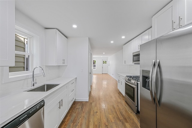 kitchen featuring sink, tasteful backsplash, dark hardwood / wood-style flooring, white cabinetry, and stainless steel appliances