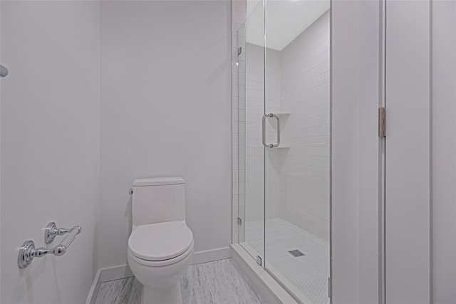 bathroom featuring toilet and walk in shower