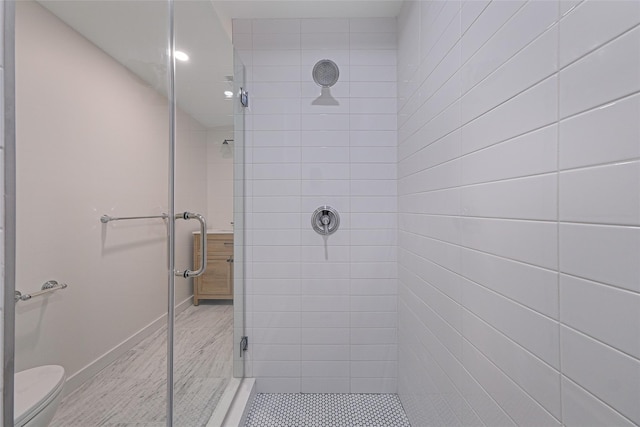 bathroom with toilet and a shower with shower door