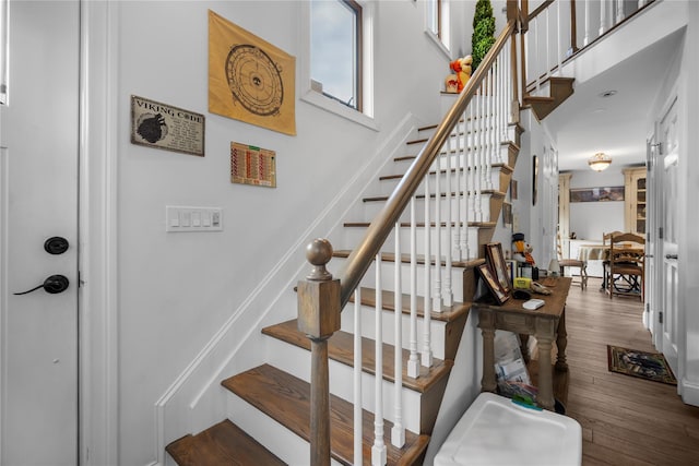 stairway featuring wood-type flooring