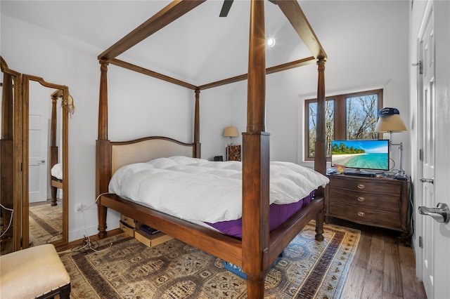 bedroom featuring lofted ceiling and dark wood finished floors