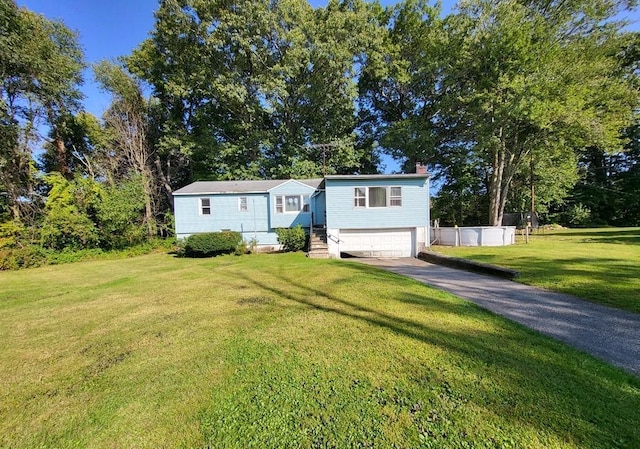 raised ranch with a front yard and a garage