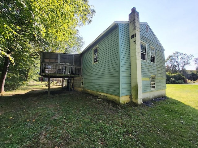 view of property exterior featuring a deck and a lawn