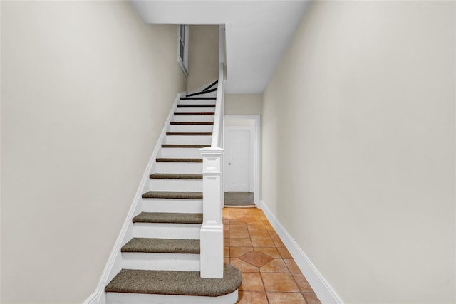 stairs with tile patterned flooring