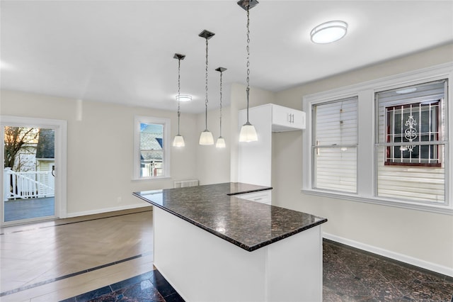 kitchen featuring pendant lighting and white cabinets