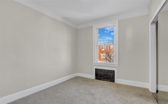 unfurnished living room with light colored carpet, radiator, and crown molding