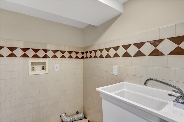 bathroom featuring tile walls and sink