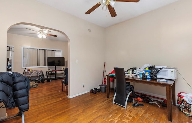 office area with ceiling fan and wood-type flooring