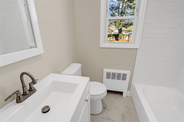 bathroom with sink, radiator heating unit, and toilet