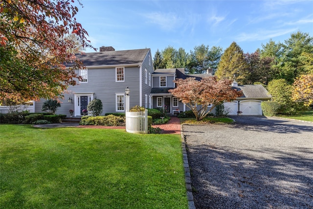 view of front facade featuring a front lawn and a garage