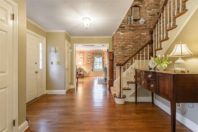 entrance foyer with crown molding and dark wood-type flooring