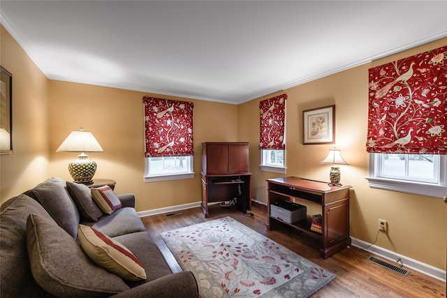 living room with hardwood / wood-style floors and crown molding