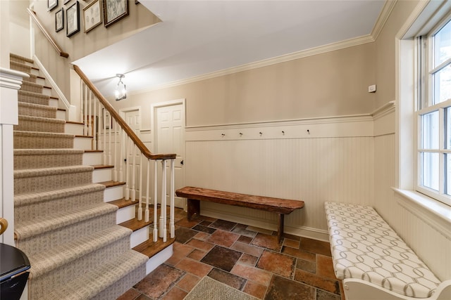 interior space with a healthy amount of sunlight, a notable chandelier, and crown molding