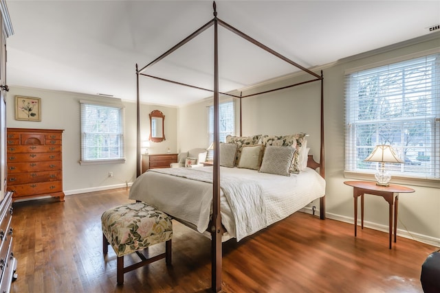 bedroom featuring multiple windows, ornamental molding, and dark hardwood / wood-style floors