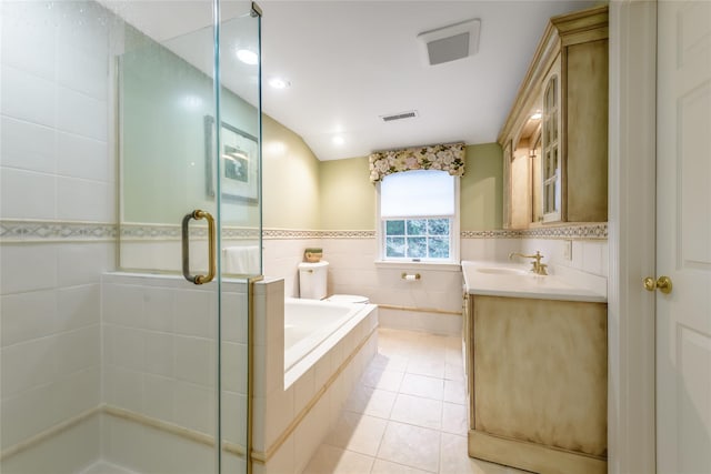 bathroom featuring tile walls, vanity, tile patterned floors, and shower with separate bathtub