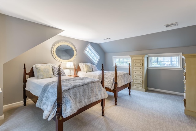 bedroom featuring vaulted ceiling, multiple windows, and carpet floors