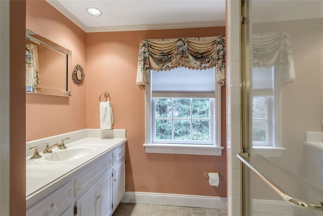 bathroom with tile patterned floors, crown molding, a healthy amount of sunlight, and vanity