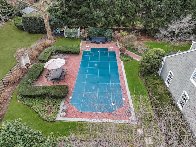 view of pool with a yard