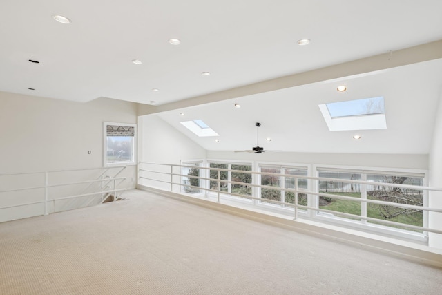 spare room with vaulted ceiling with beams, ceiling fan, and light carpet