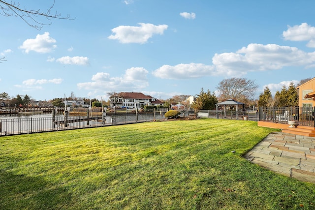 view of yard with a gazebo and a water view