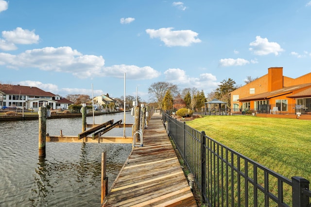 dock area featuring a water view and a yard